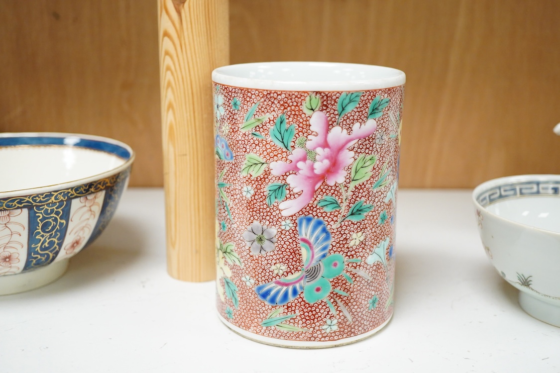 A Chinese famille rose cylindrical brush pot enamelled with butterflies amongst flowers, 14cm high